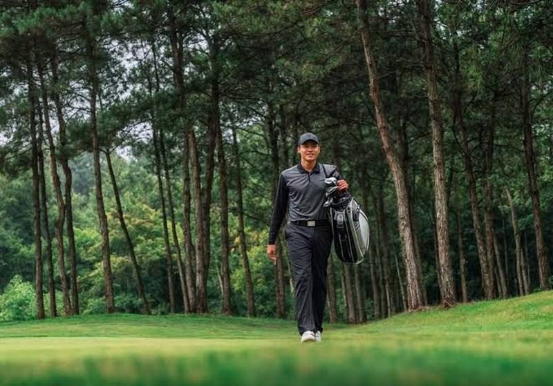 Golfer walking the fairway with his bag